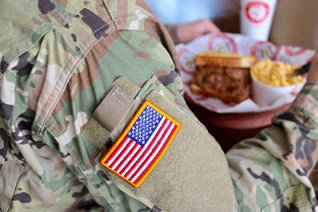 Military man eating at Shane's Rib Shack